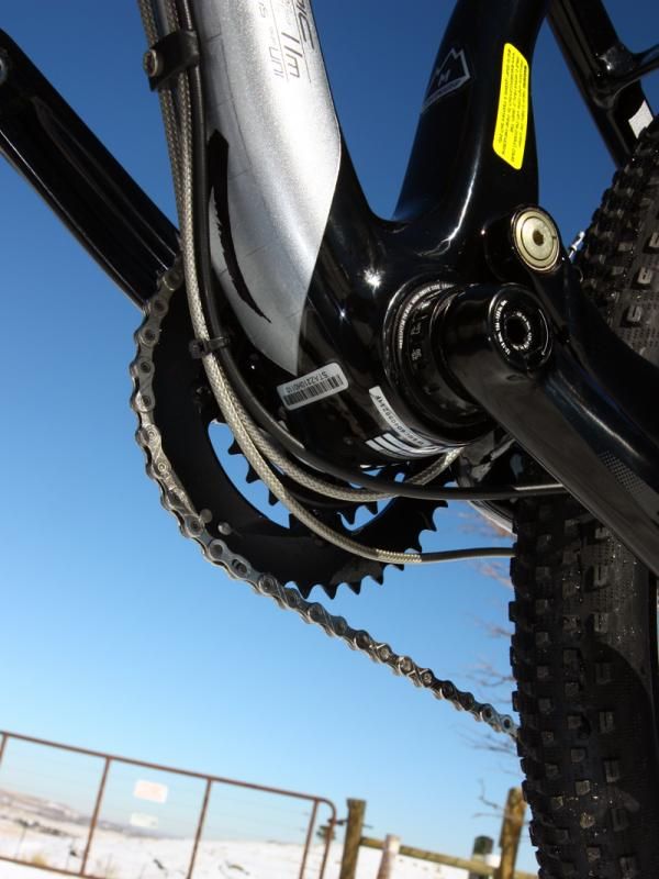 Cables are routed underneath the down tube and loop below the bottom bracket shell.