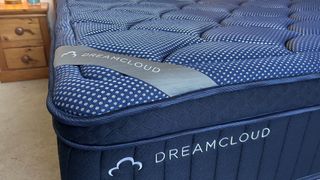 Close detail images of the DreamCloud Luxe Memory Foam mattress, showing design features like the quilted top of the bed and the handles sewn onto the sides