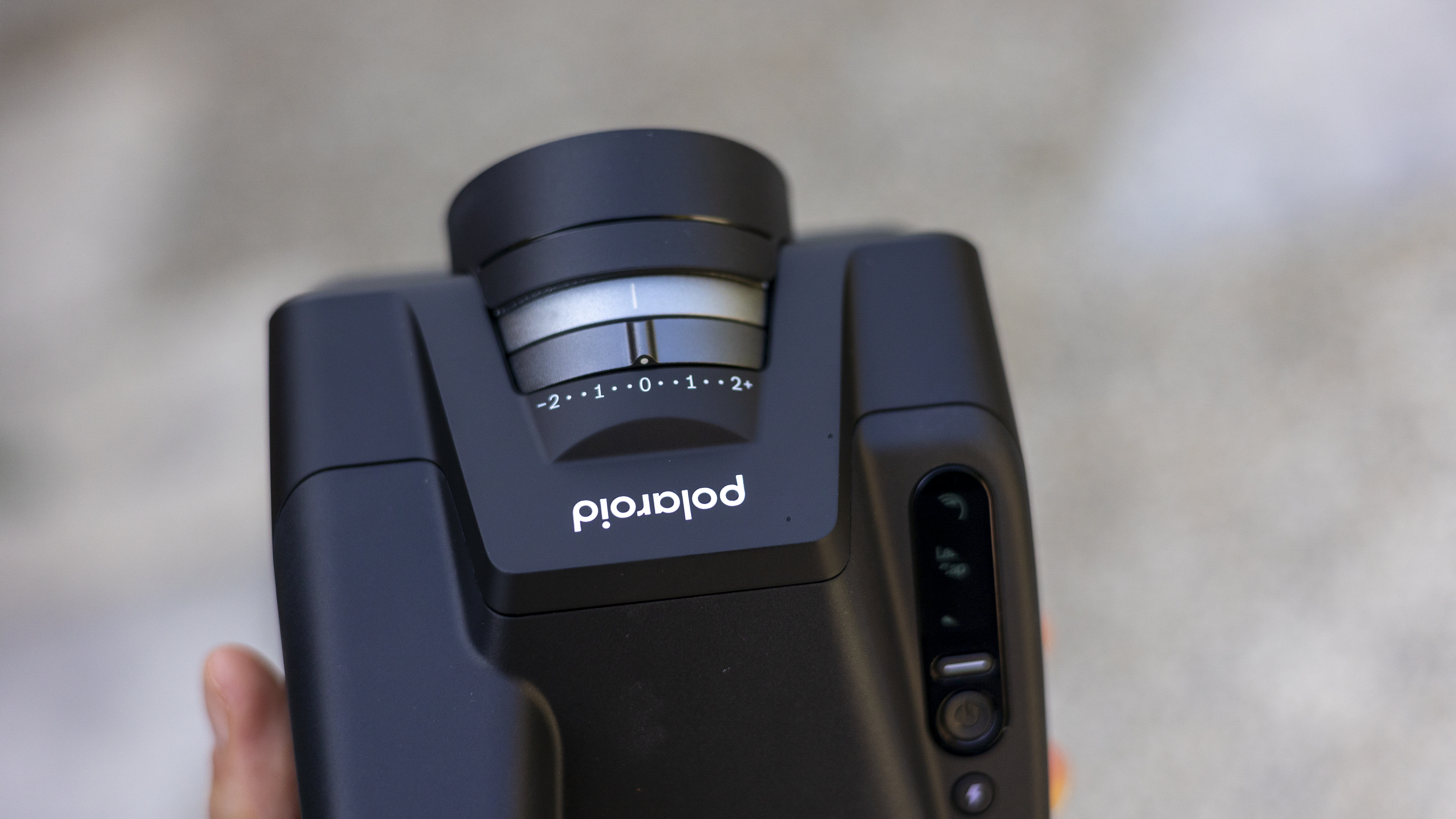 The top of the Polaroid I-2 instant camera with the exposure compensation dial