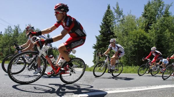 Team BMC's Jackson Stewart (left) leads a group part of the peloton into a tight curve.