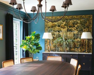 Blue dining room with sideboard and large tapestry on wall