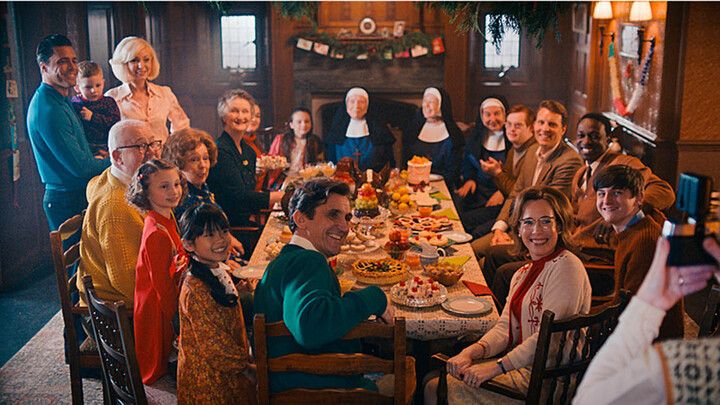 The Call the Midwife cast sitting round a dinner table for the 2023 Christmas special 