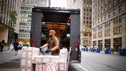 A UPS driver unloads his truck in New York City in August 2023. 