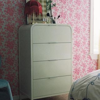 Urban Outfitters Kane Dresser against a pink and white patterned wall.