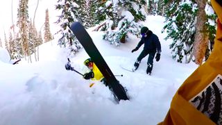 Snowboarders rescuer skier trapped in snow