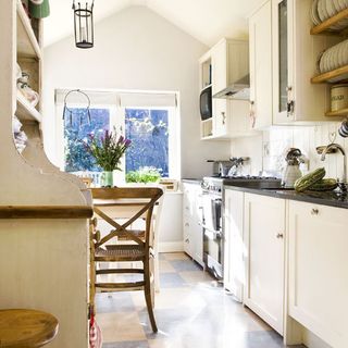 kitchen with cream cabinets and table and chairs