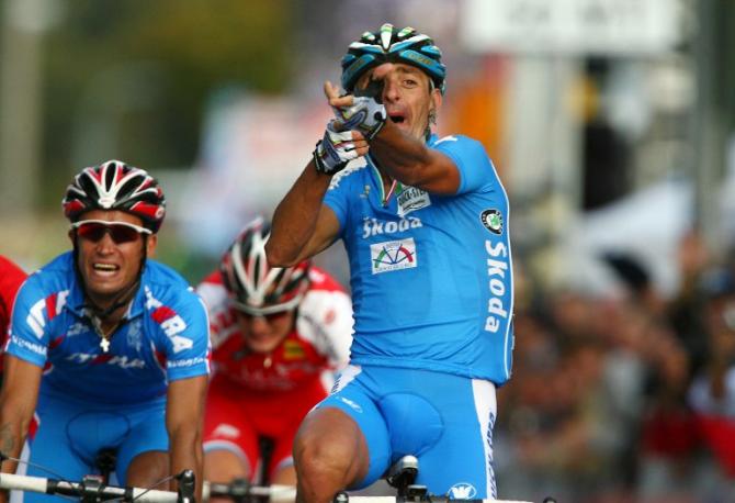 Italy's Olympic champion Paolo Bettini, left, looks at his