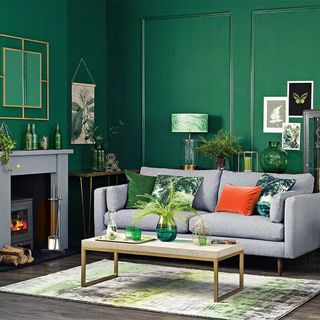 green living room with panelling and grey fireplace and sofa