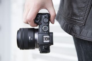 The Canon EOS RP being held by the side of a photographer