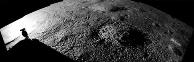 An image showing Yutu-2's shadow and tracks from when it approached the crater.