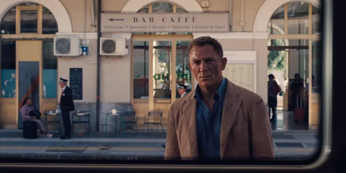 No Time To Die Daniel Craig stands sadly outside the train window