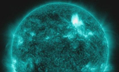 Solar Dynamics Observatory captures a massive solar flare, shown here in teal, exploding off the face of our sun 93 million miles away.