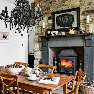 dining room with fireplace and exposed brick wall