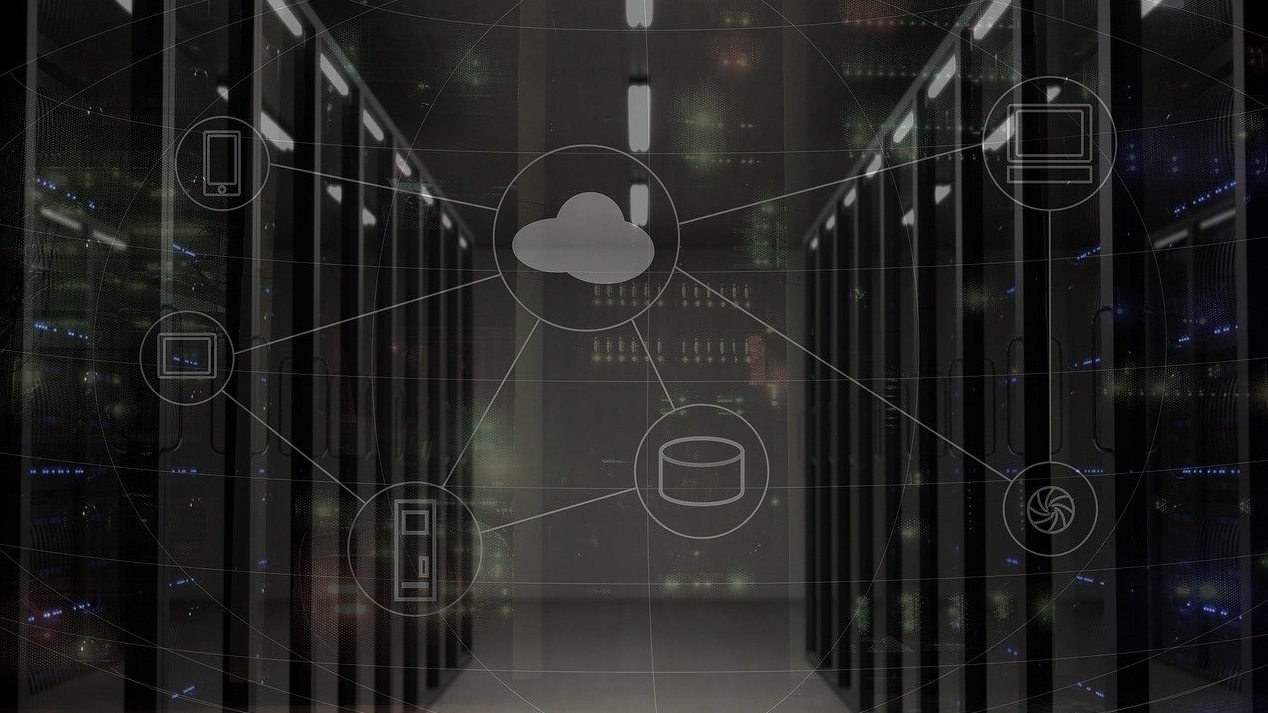 A cloud symbol imposed over an image of server racks in a data center.