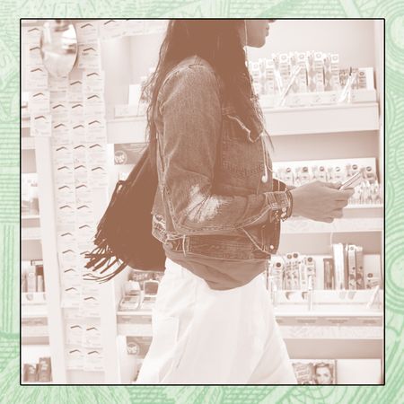 A woman walks through the aisles of Ulta.