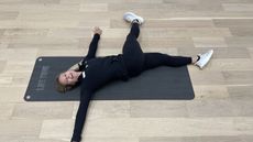 Woman demonstrates stretches in a fitness studio