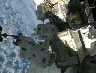 Astronauts and Pump Module During Spacewalk