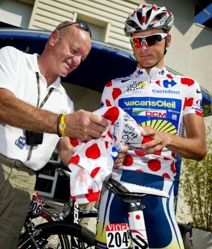 Johnny Hoogerland (R) wears the polka dot jersey while giving an autograph on the first rest day of the Tour de France. The Dutchman is hoping to recover over the next 24 hours after being hit by a car on stage nine.