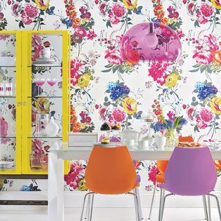 dining room with bright floral print wallpaper