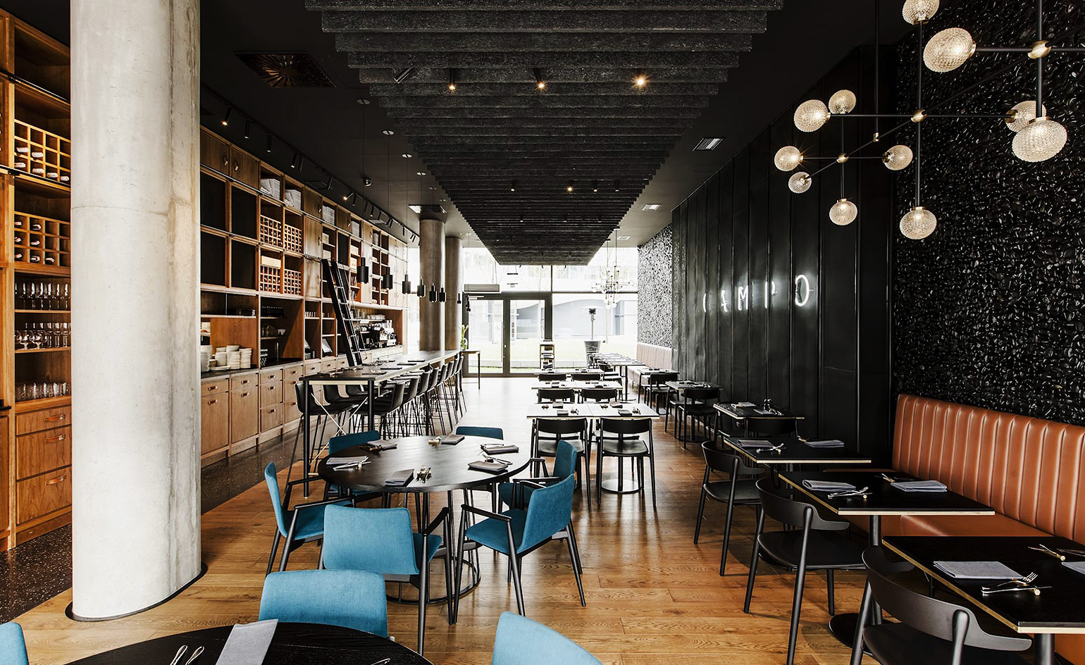 Campo Restaurant in Poland with black walls, table and chairs with wooden floors