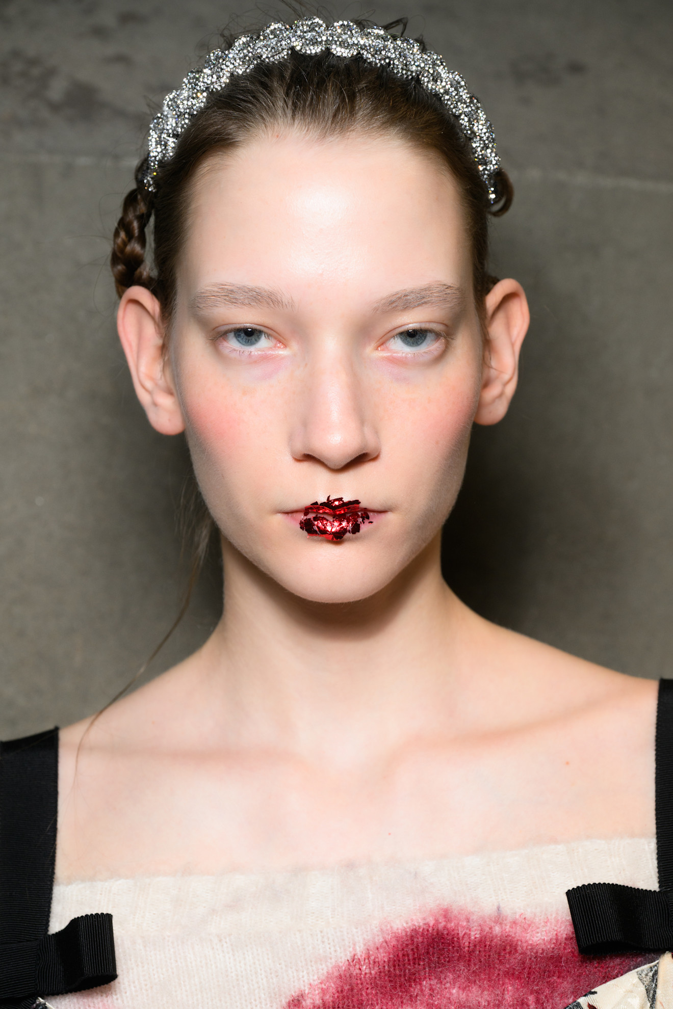 model with dark brunette hair wearing a silver rhinestone headband