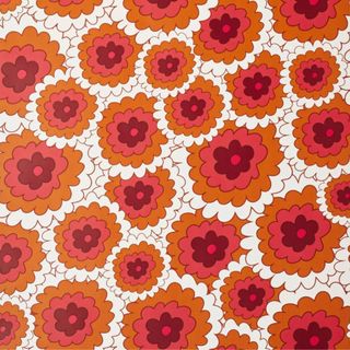 Penelope Flower Wallpaper in pinks, reds, and whites in circular tile shapes