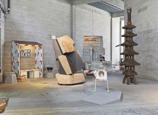Collection of sculptures on display at an exhibition by Tom Sachs