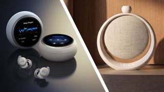 The Anker Sleep 4 earbuds on a table next to the Anker SleepLab speaker on a bedside table
