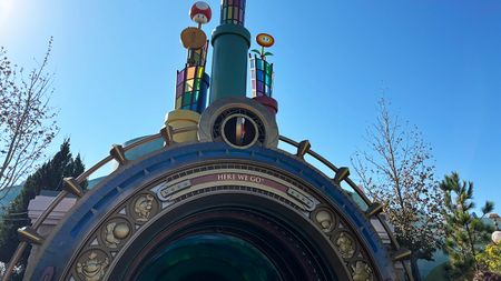 The Portal Outside Super Nintendo World at Epic Universe during daylight hours. The Mario coin is spinning.