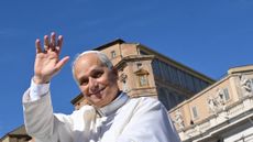 Pope Leo XIV waves at the audience in St. Peter’s Square.