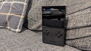 Analogue Pocket review; a small handheld on a sofa