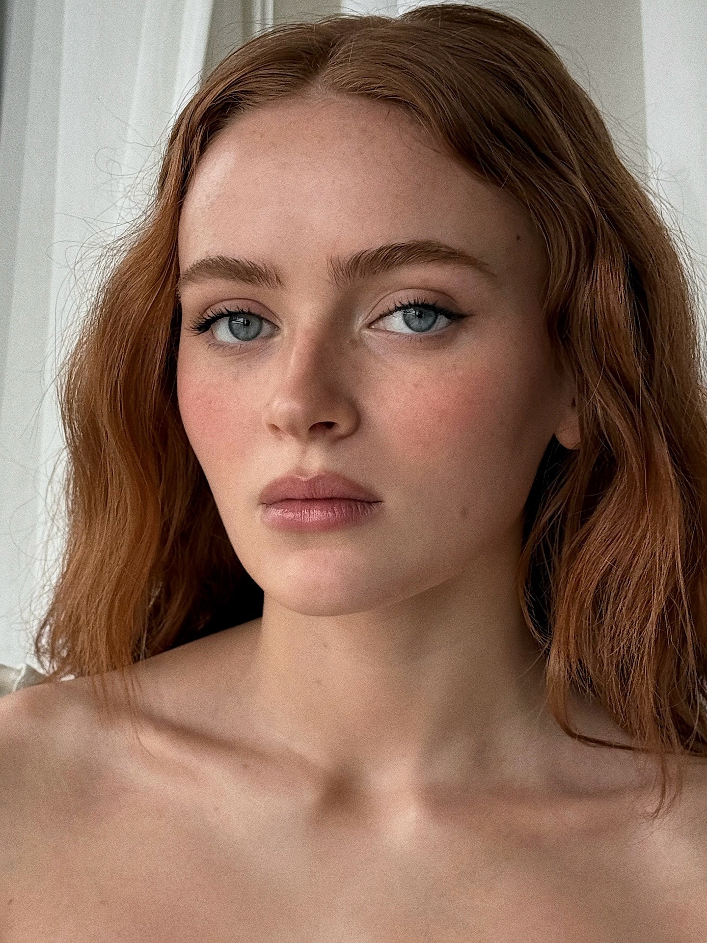 Sadie Sink wearing a soft pink blush on the apples of her cheeks