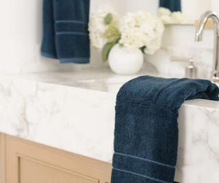 Bamboo bath towels draped over a bathroom sink.