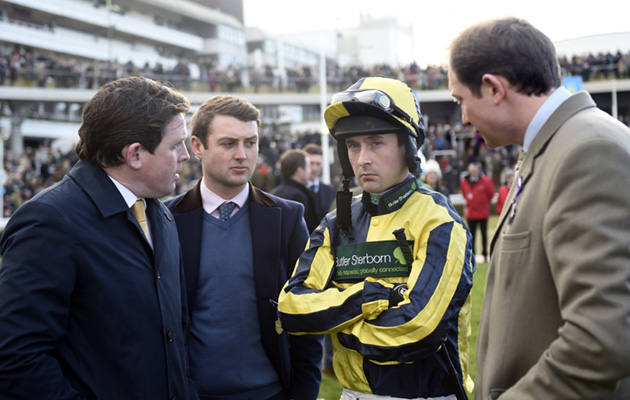 Jockey Nico de Boinville is a picture of concentration in the paddock with connections, including the owners&rsquo; manager, former top jockey Jason Maguire (left)