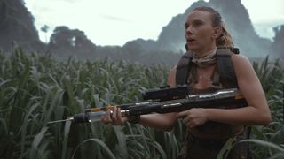 Scarlett Johansson's Zora holding a tranquilizer rifle in Jurassic World Rebirth