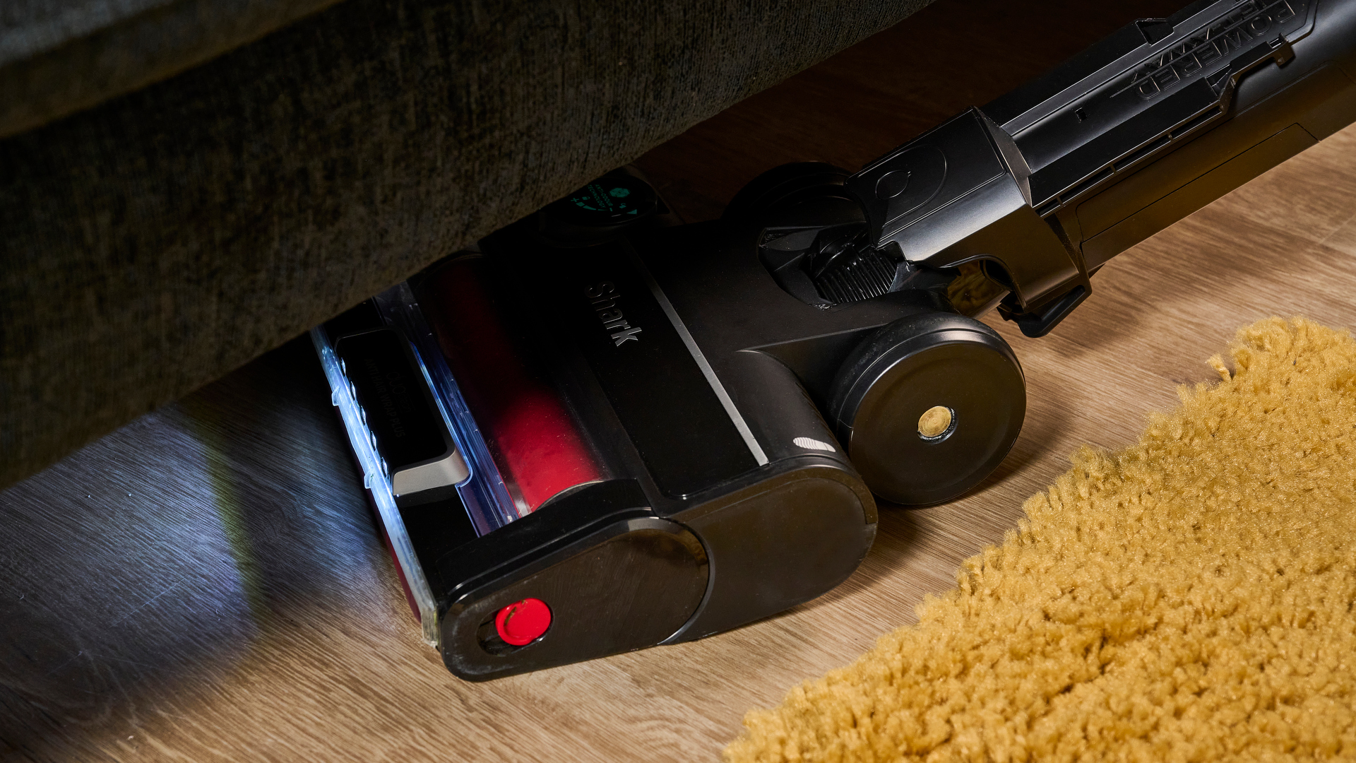 Cleaning under furniture with the Shark Stratos Pet Pro Upright Vacuum