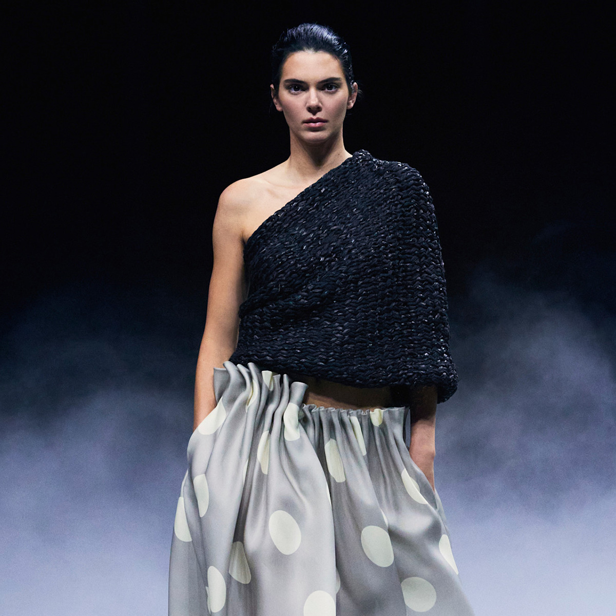 Kendall jenner wears a black crochet top and polka dot skirt.