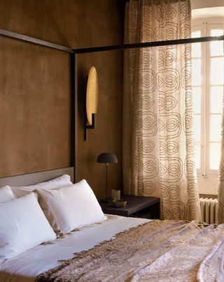 an earth tone bedroom with gold touches
