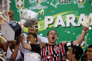 Rogerio Ceni celebrates with the Brazilian championship trophy won by Sao Paulo in 2008.
