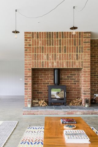 brick fireplace with interesting ceiling lighting