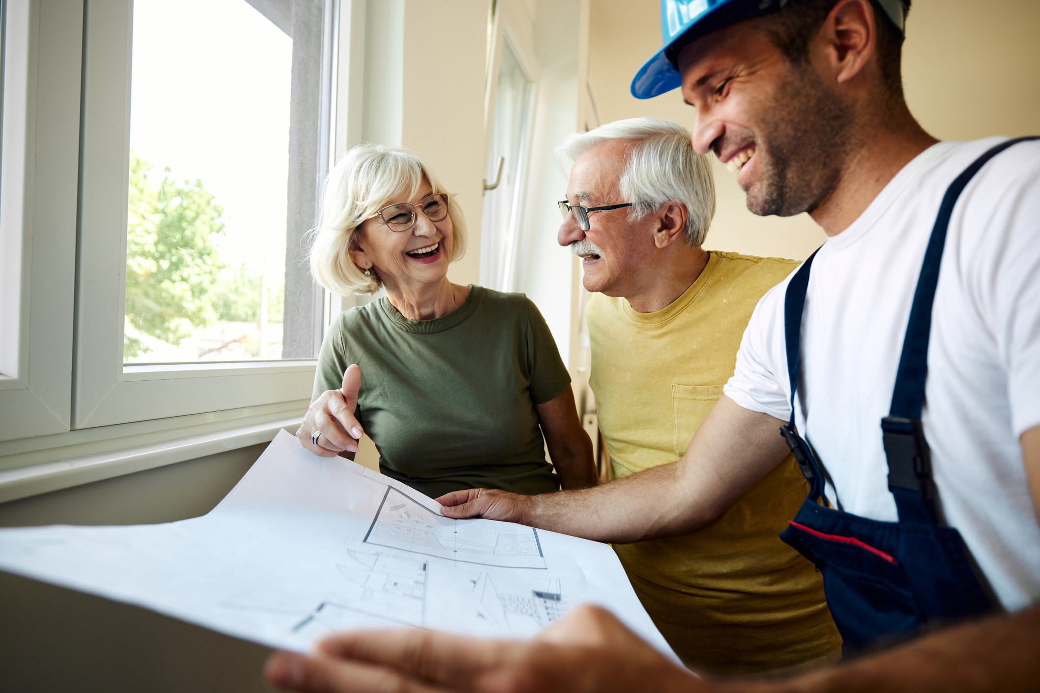 A couple going over plans with a home contractor.