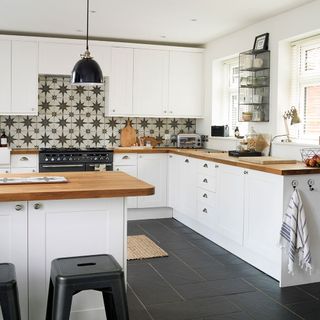 kitchen with wall and white cabinet