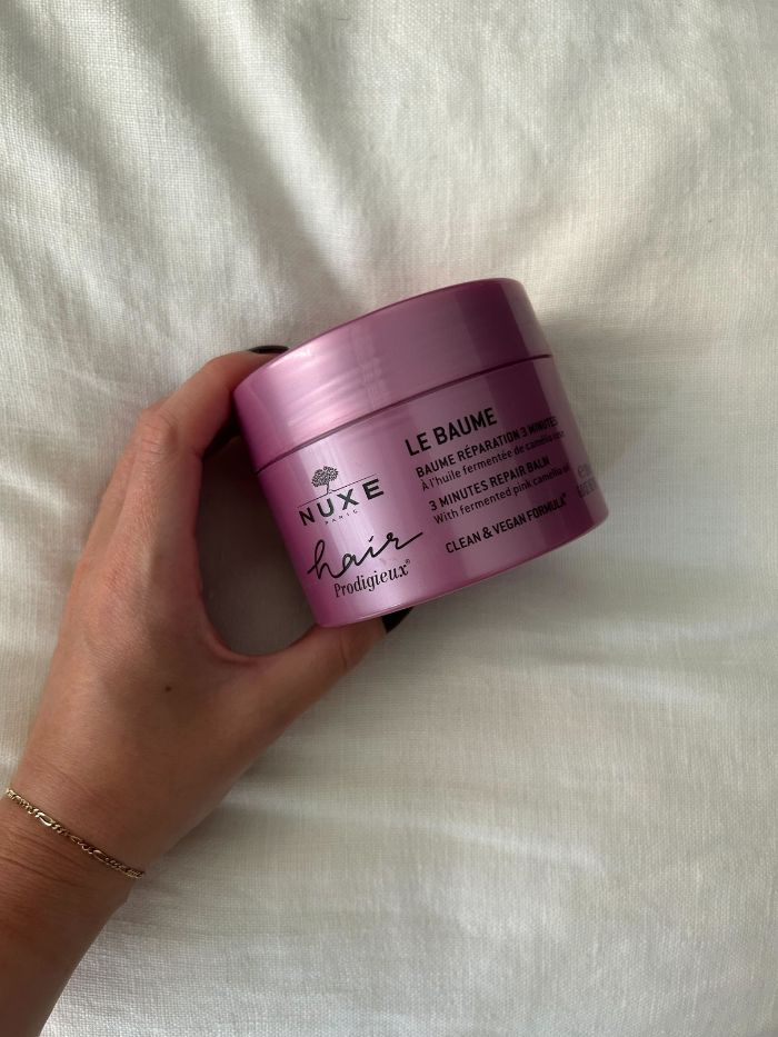 junior beauty editor grace lindsay holding a nuxe hair mask