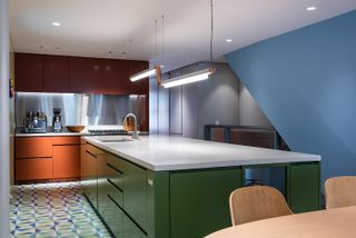pastel kitchen with green island and blue cabinets