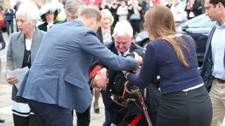 Prince William helps elderly man