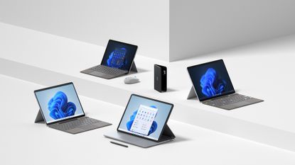 The Microsoft Surface range of devices in silver and black on a white background