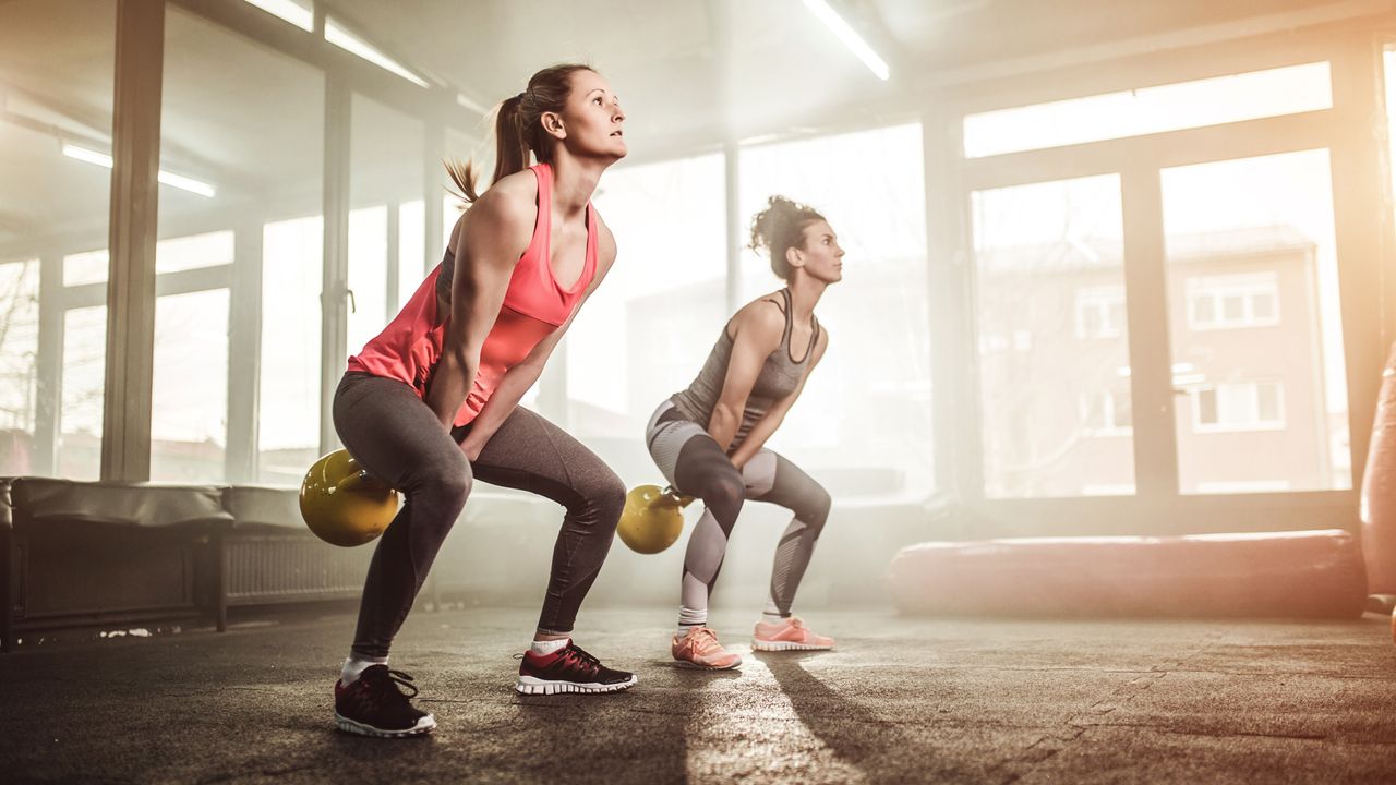 Women performing kettlebell swings