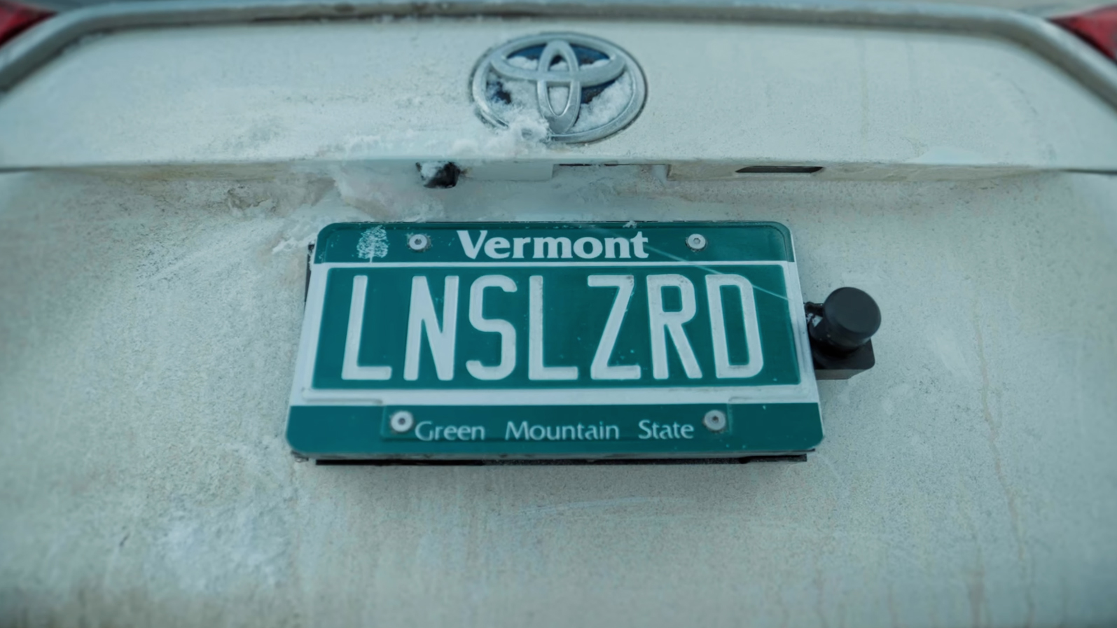 The Lens Lizard squirts cleaner at a backup camera