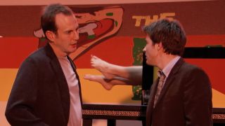 Will Arnett as Gob Bluth and Jason Bateman as Michael Bluth stand in front of a "Saw the Lady in Half" magic trick on Arrested Development.