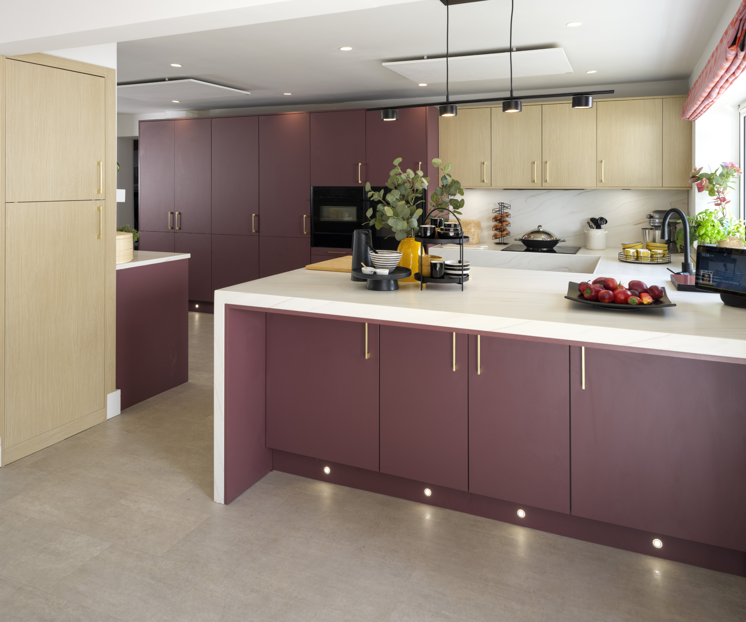 burgundy and wood kitchen with accessible design features and white worktops